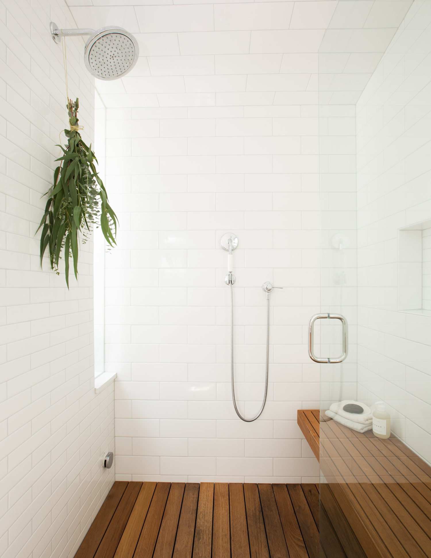 white tile walls and wood floor shower